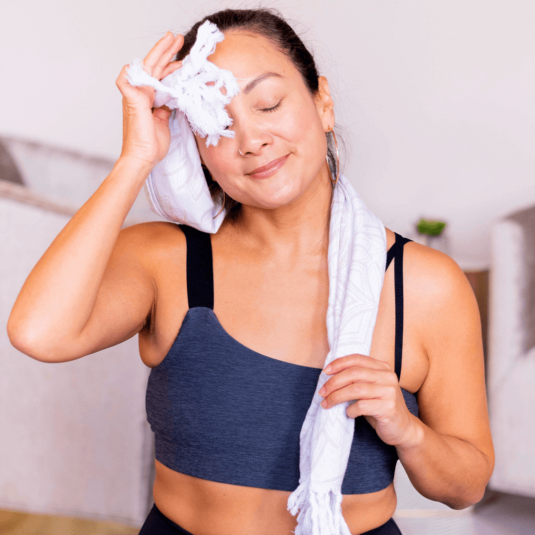  Happy woman using an oat and white Turkish hand towel for yoga practice