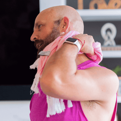 man using a pink Turkish hand towel after yoga practice
