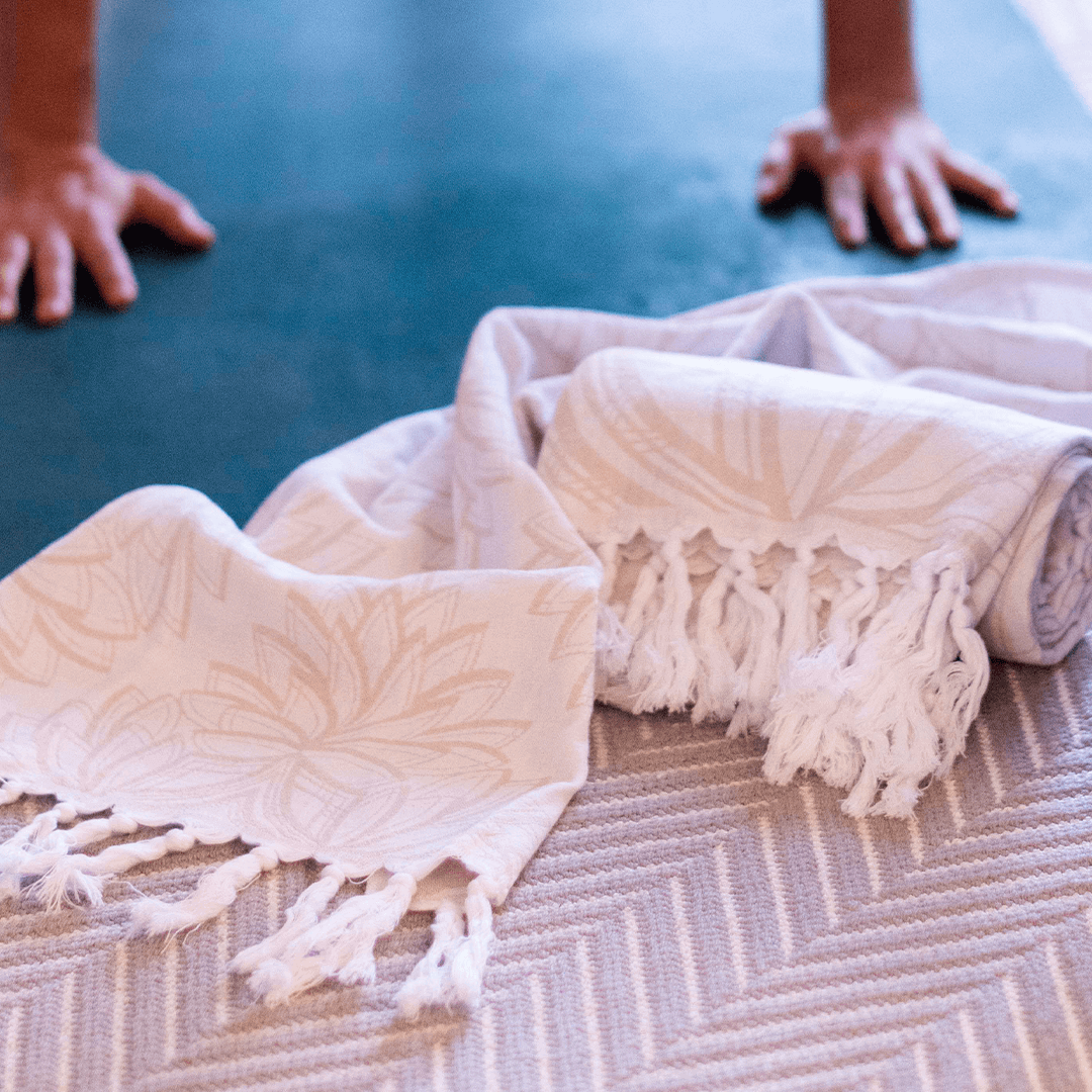 smiling woman using a Turkish towel after yoga