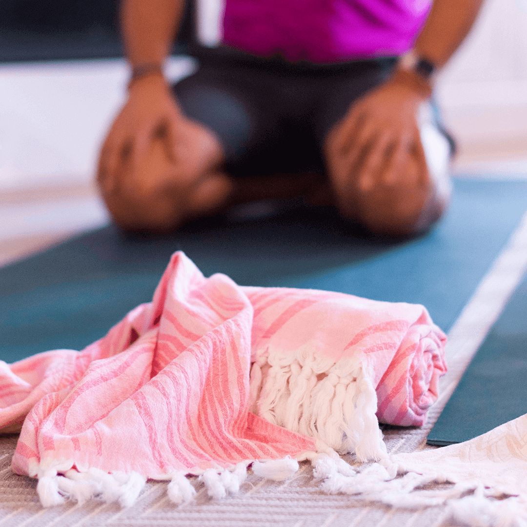 Pink stripped Turkish towel used during Yoga practice