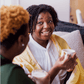 smiling woman using a yellow Turkish towel as a light blanket