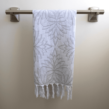 Grey and white Turkish hand towel hanging on the towel rack