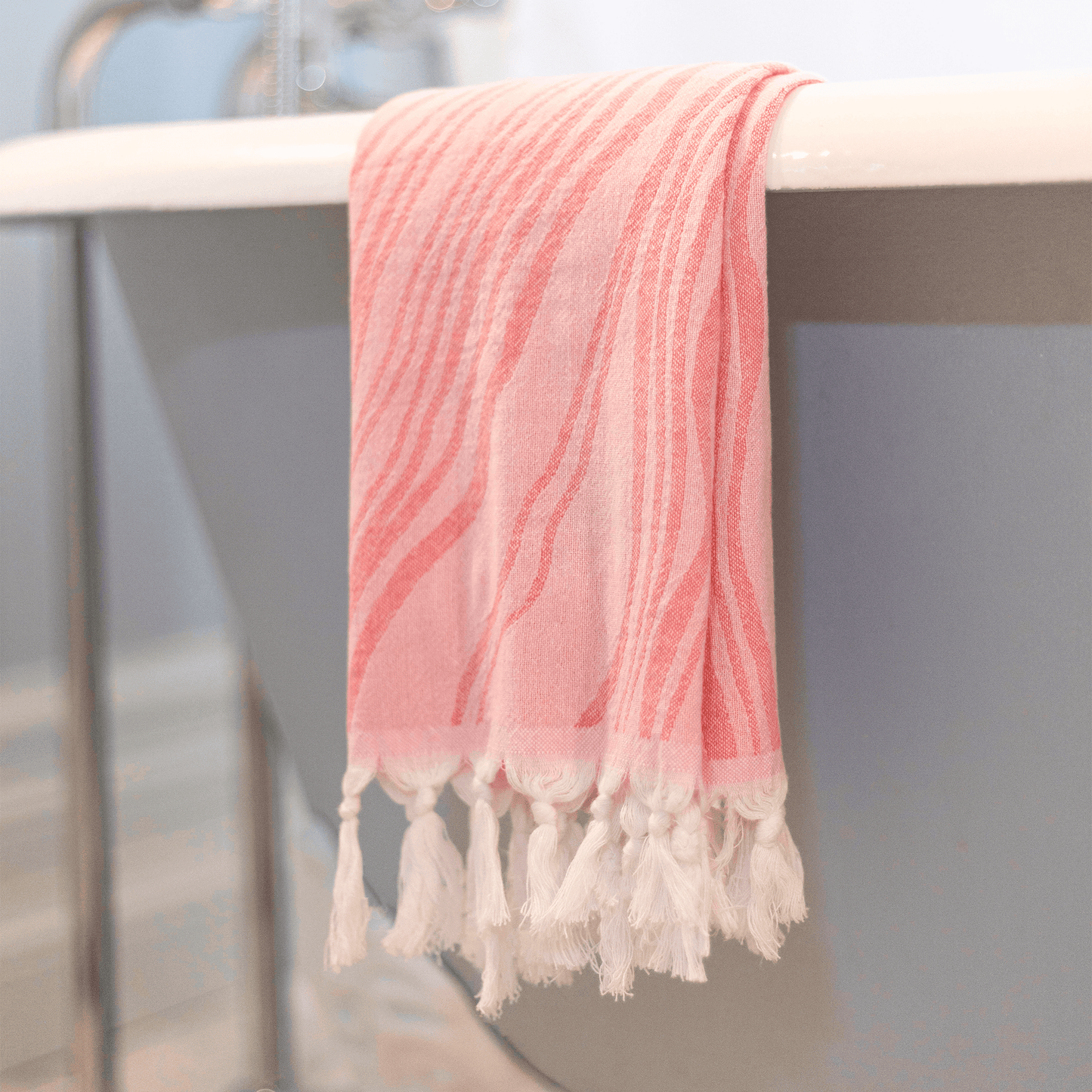 Pink Turkish hand towel hanging in the bath