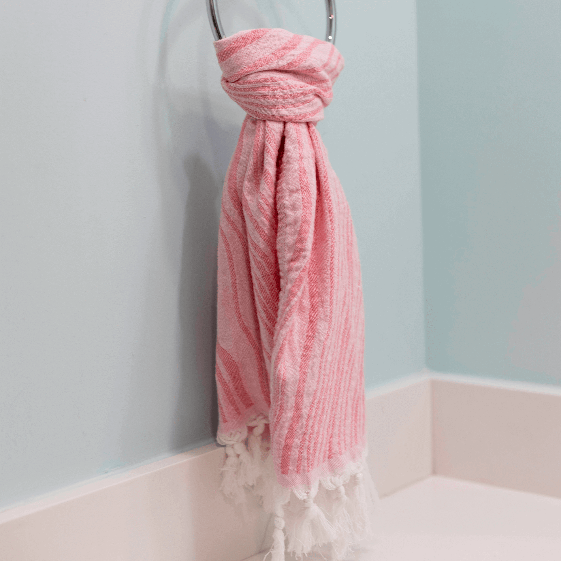 Pink Turkish hand towel hanging in the bath as a hand towel