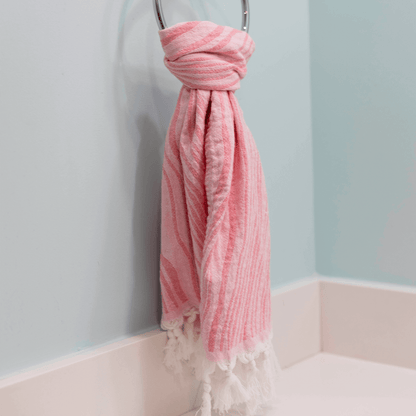 Pink Turkish hand towel hanging in the bath as a hand towel