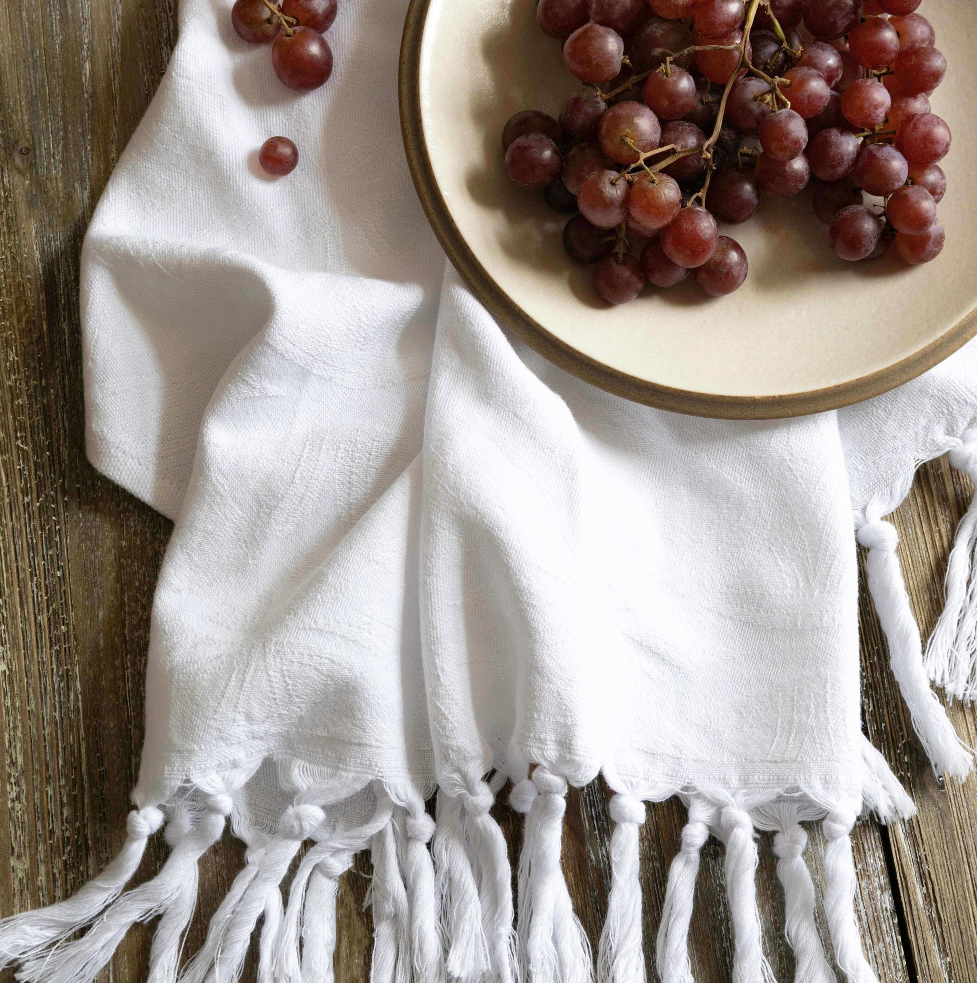  White Turkish towel with grapes on a plate