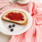 Pink Turkish towel in the kitchen with toast and jam
